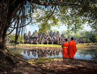 Buddhist monks near Angkor Wat temples in Cambodia - 99875254