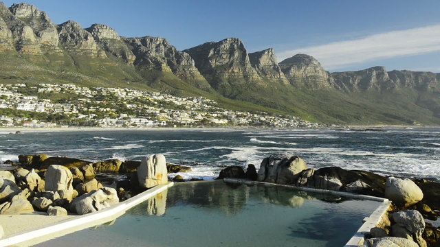 Beautiful Camps Bay at the base of Table Mountain in Cape Town, South Africa at sunset in high definition footage