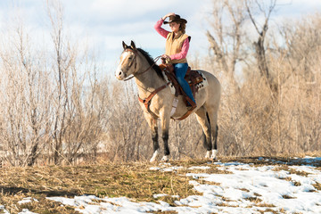 Woman Riding Buckskin