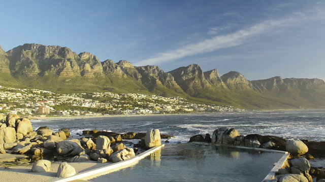 Beautiful Camps Bay at the base of Table Mountain in Cape Town, South Africa at sunset in high definition footage