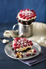 Sweet cakes with raspberries on color wooden background