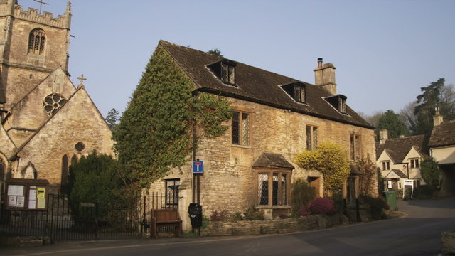 Old stone buildings and a church in a village in England.