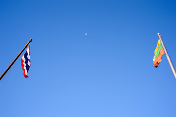 Thai and Myanmar national flags waving inside the moon