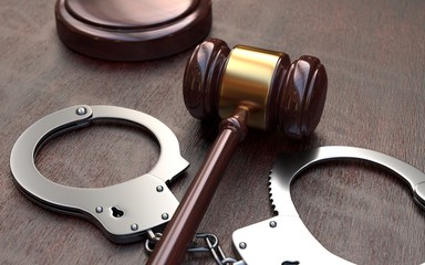  Gavel and handcuffs on wooden table background
