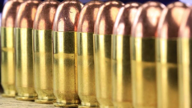 Copper plated bullets with brass slugs lined in a row