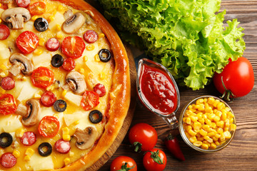 Delicious pizza with vegetables and meat, close-up