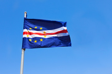 Cape verde flag waving on wind over a blue sky