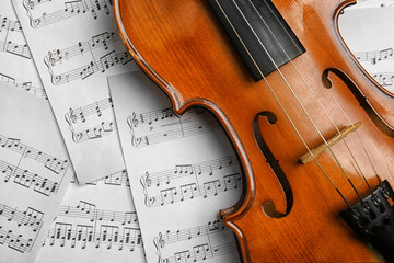 Fototapeta premium Violin on music papers background