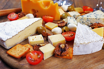 Cheese ready for tasting on wooden background, closeup