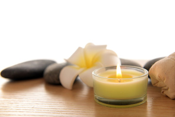 Fototapeta na wymiar Massage bags with plumeria and candle, isolated on white
