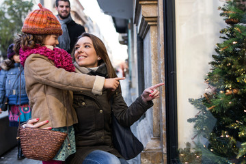 Happy young family having fun in the street.