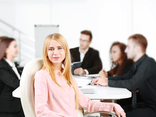 Photo of business woman with her staff in conference room at the meeting