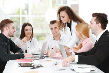 Fototapeta premium Young business people discussing a new project in a conference room