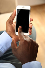 Afro american man with a smartphone indoor