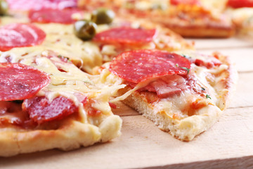 Delicious tasty pizza with cut slice, closeup