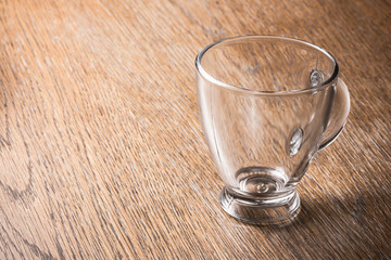 Empty coffee expresso glass transparent cup on wood.