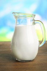 Jar of milk on blurred natural background