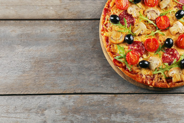 Delicious tasty pizza on wooden table