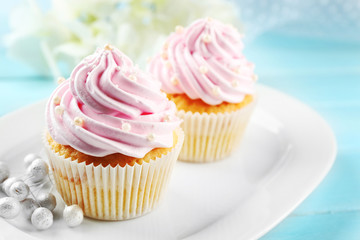 Pink cupcakes on wooden background