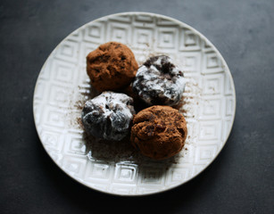Chocolate balls with ash berry on plate, top view