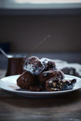Chocolate balls on a plate on wooden background