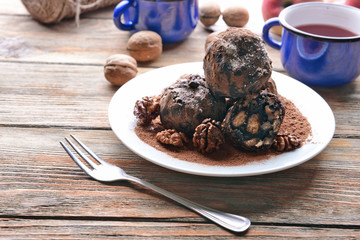 Chocolate sweets with spices on wooden table