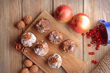 Chocolate sweets with spices on wooden background