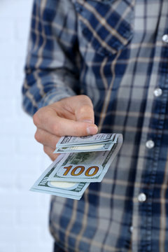 Man holding dollars in hand