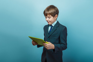 Teen  boy of twelve European  appearance in a business suit hold