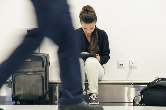Young backpacker woman waiting for her flight.