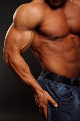 Fototapeta na wymiar Muscular body of man on gray background