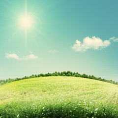Beauty seasonal backgrounds with green hills under blue skies