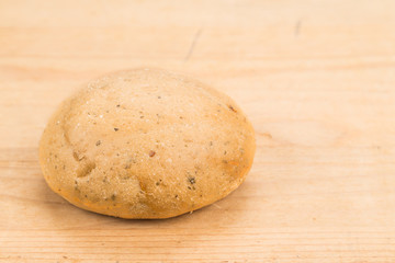 Freshly baked healthy gluten-free delicious wholemeal buns with herbs on wooden surface