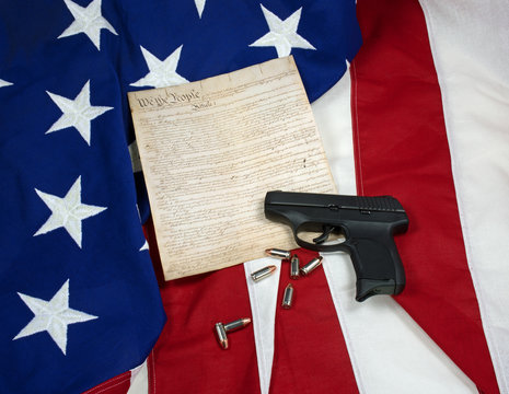 Constitution with Hand Gun & Cartridges on American Flag