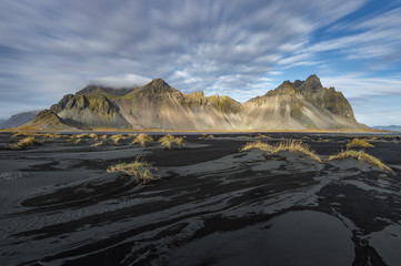 Black sand beach  with mountain range background in sunny day Vesturhorn Iceland