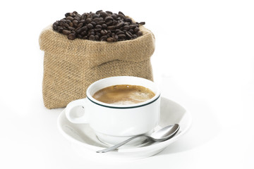 Cup and coffee beans in sack