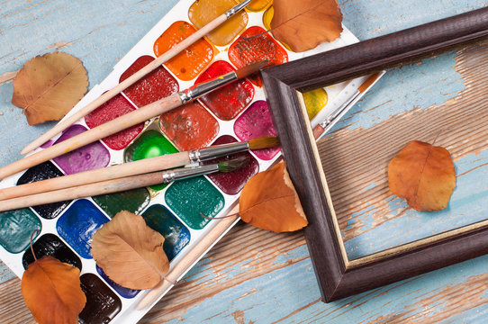 Paint brushes , paint and frame autumn