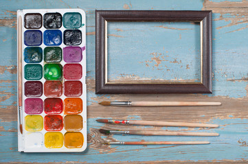 Paint brushes , paint and frame autumn