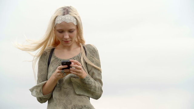 Young woman uses mobile smartphone outdoor  slow motion  
