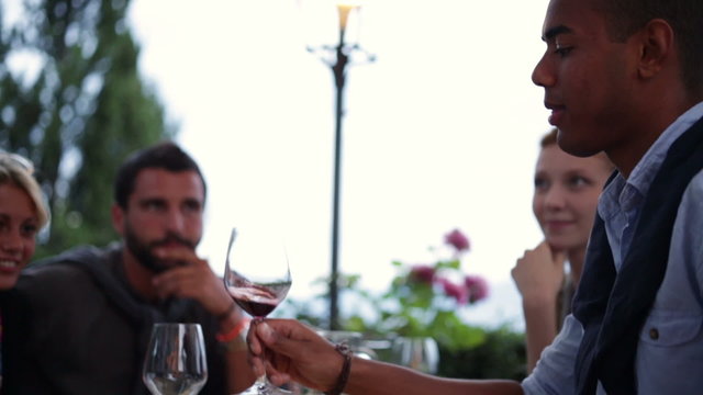 Man with his friends taste a wine glasses