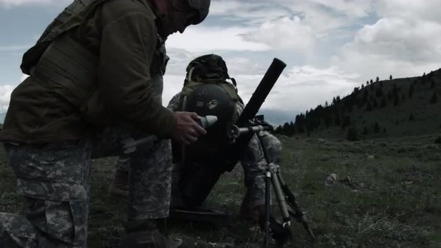 Shot of soldiers setting up mortar system.