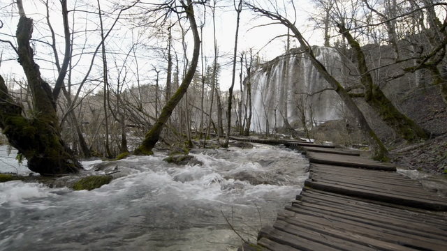 Walking on boarwalk throughout plitvice lakes national park waterfall   