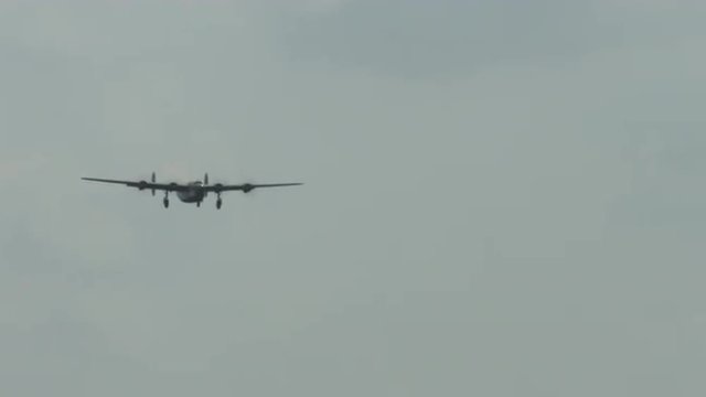 B-24 Liberator from World War II flies with undercarriage down.  Recorded in 4K, ultra high definition.