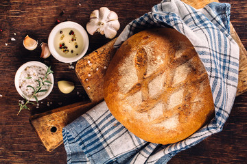 Freshly baked traditional bread on wooden table