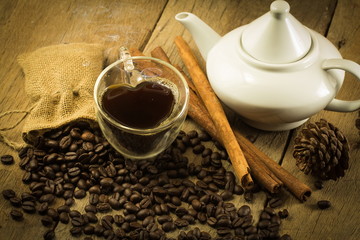 Heart shape cup, Teapots and Coffee beans on wooden and hemp sac