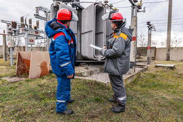 Electricians on high voltage substation