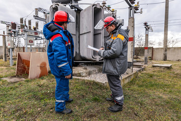 Electricians on high voltage substation