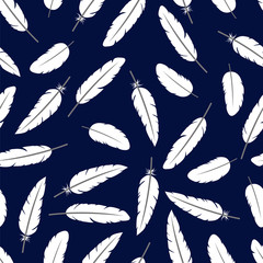 The feathers on dark blue background. Seamless pattern.