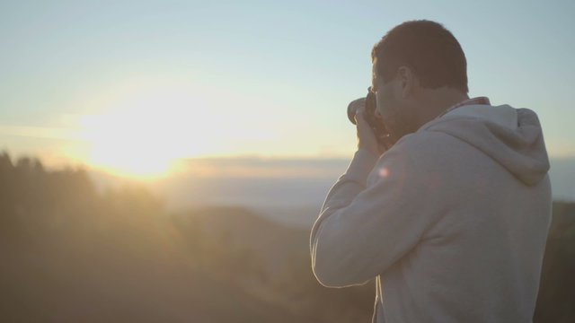 Man shoot photos at sunrise or sunset  slow motion  