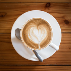 Hot art Latte Coffee in a cup on wooden table.